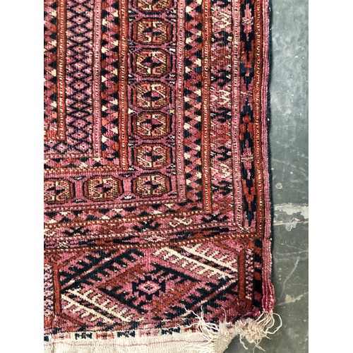 725 - A red ground tekke Turkmen rug, 180x107cm