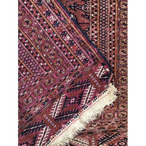 725 - A red ground tekke Turkmen rug, 180x107cm