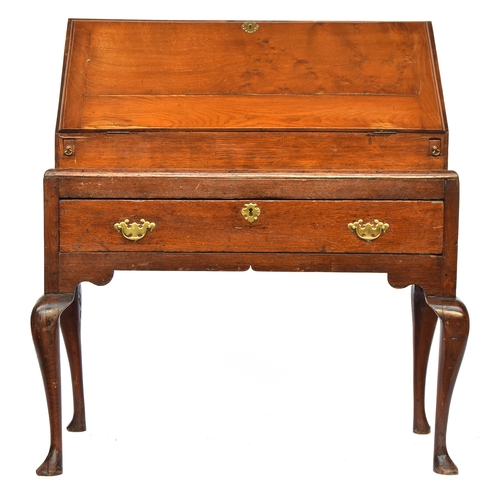 755 - An early 18th century oak bureau on stand, the fall front opening to a fitted interior with well, ov... 