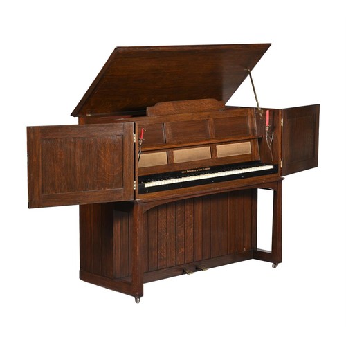 754 - An oak and brass mounted upright piano c.1900, by Mackay Hugh Bailie Scott (1865-1945) for John Broa... 