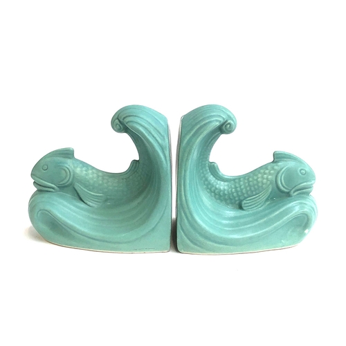 77 - A pair of Art Deco Langley Pottery green glazed dolphin bookends designed by Frank Mitchell