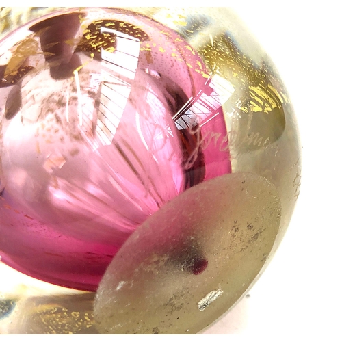 99 - A hand blown paperweight by Roger Gandelman, blue with pink flowers, signed and dated 1988; together... 