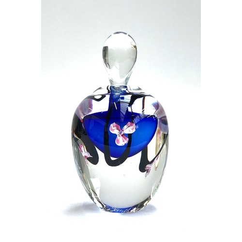 99 - A hand blown paperweight by Roger Gandelman, blue with pink flowers, signed and dated 1988; together... 