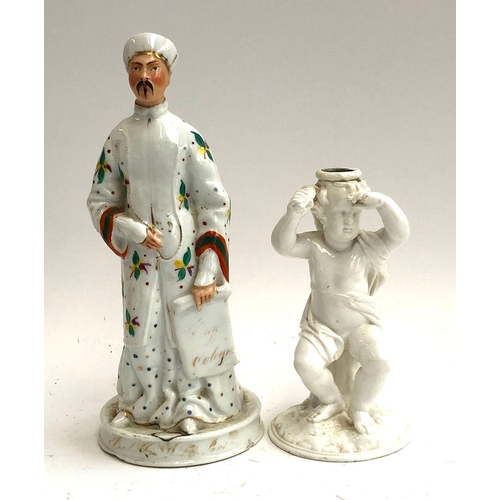 106 - A 19th century figure of an Ottoman gentleman, 27cmH; together with a porcelain candlestick holder i... 