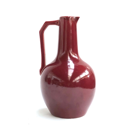 109 - Christopher Dresser for Lear Pottery, a late 19th century Sang de Bouef glaze jug c.1880, 26cmH