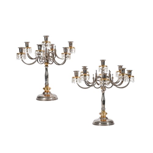 757 - A pair of 20th century chrome and gilt metal seven light candelabra, the drip-pans with facetted gla... 