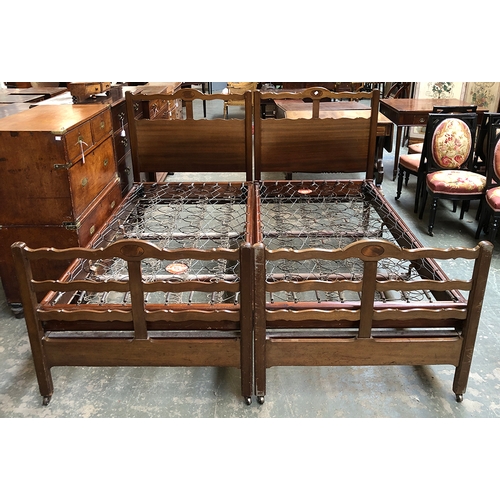 780 - A pair of 20th century mahogany single beds by Heal & Son ltd, each with Staples mattress frames and... 