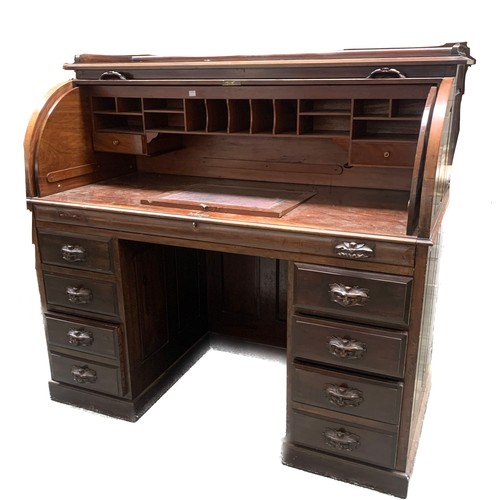 789A - A late 19th century roll top writing desk, the top with a three quarter moulded gallery, the rolltop... 