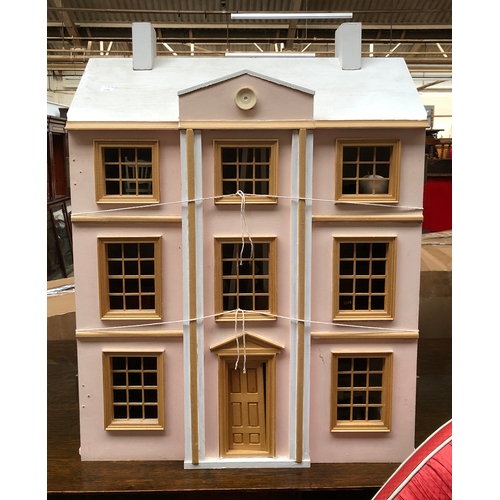 753 - A pink painted dolls house, 61cmW