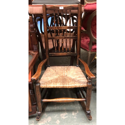 759 - An ash spindleback rocking chair with rush seat; together with a red stained occasional chair, with ... 