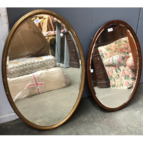 792 - A gilt framed oval wall mirror, with bevelled glass, 93x62cm; together with an oak framed oval mirro... 