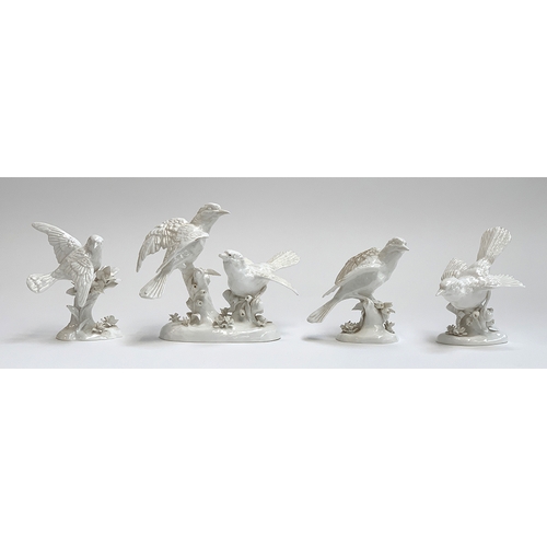 86 - A collection of four Crown Staffordshire white glaze bird figurines, modelled by G.T Jones, two af, ... 