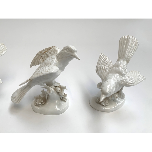 86 - A collection of four Crown Staffordshire white glaze bird figurines, modelled by G.T Jones, two af, ... 