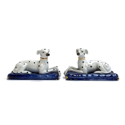 87 - A pair of Staffordshire style porcelain spotted long dog figurines heightened in gilt, each 13cmL