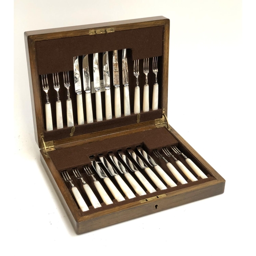 69 - A Mappin & Webb oak cased canteed on mother of pearl, plated, and stainless fruit knives and forks f... 