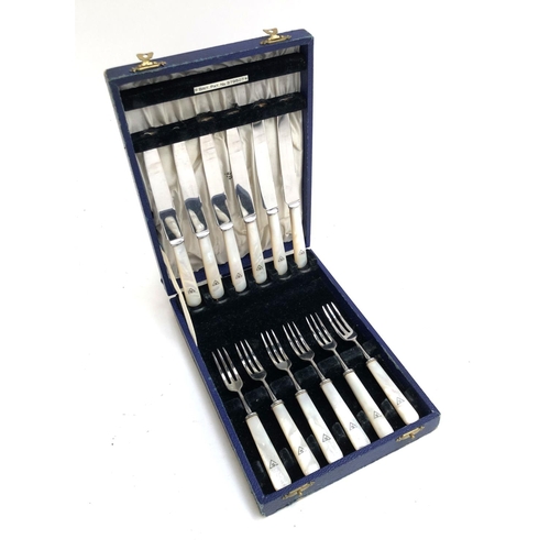 69 - A Mappin & Webb oak cased canteed on mother of pearl, plated, and stainless fruit knives and forks f... 