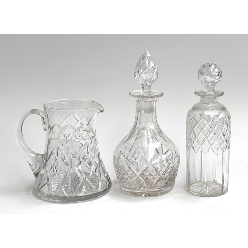 109 - A Stuart crystal cut glass decanter, 27cmH; together with a further decanter and cut glass jug