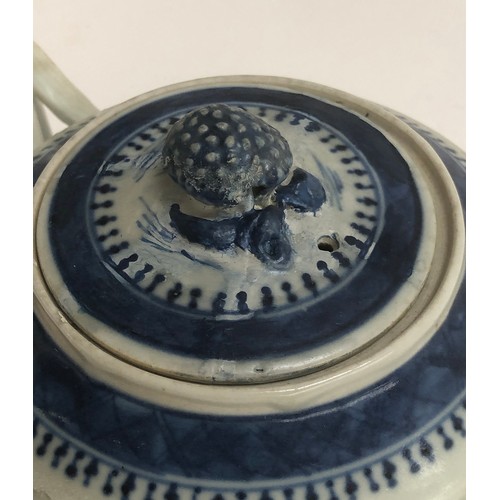 120 - A Chinese export blue and white teapot of cylindrical form with entwined bifurcated handle, repairs ... 