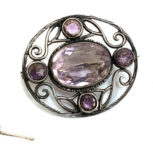 42 - A sterling silver and amethyst arts and crafts style brooch; together with various pairs of silver e... 