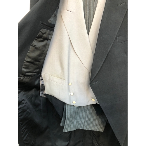 533 - A Denman & Goddard morning suit c.1959, with striped trousers, black single breasted waistcoat, and ... 