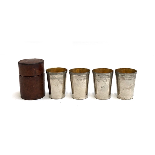 129 - A set of four stirrup cups by Swaine-Briggs, gilt interiors, in leather case