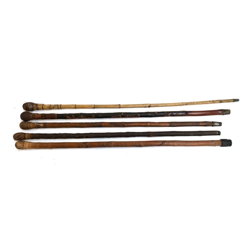 71 - A lot of five Japanese carved walking canes, some bamboo, carved with samurai, goldfish etc (5)