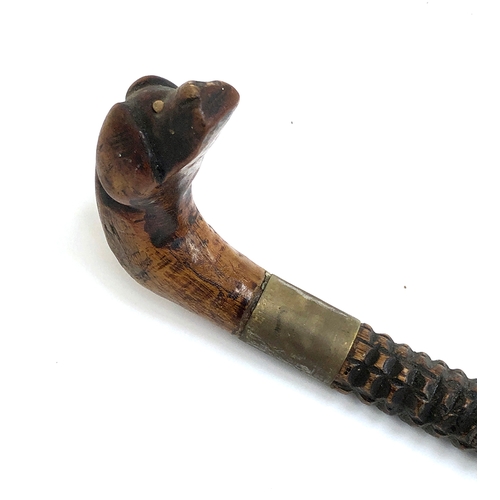 87 - Folk art interest: a naively carved walking stick with dog mask handle, 83cmL