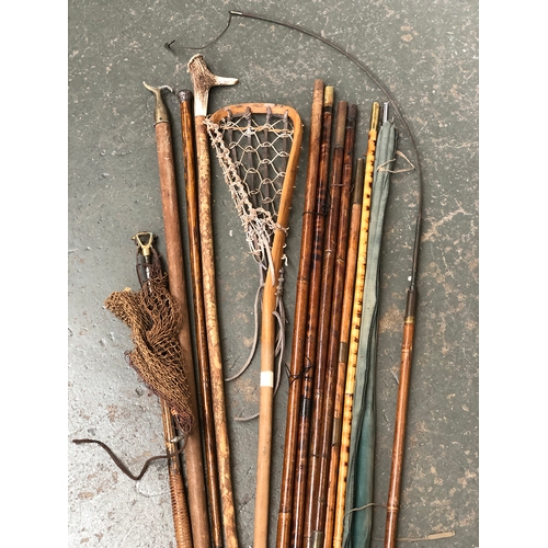 92 - A mixed lot to include antler and hazel walking stick, vintage lacrosse stick, bamboo rods, silver t... 