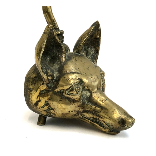 119 - A late 19th century brass fox mask door stop, with elongated handle 58cm high