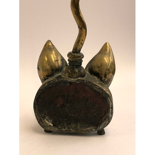 119 - A late 19th century brass fox mask door stop, with elongated handle 58cm high