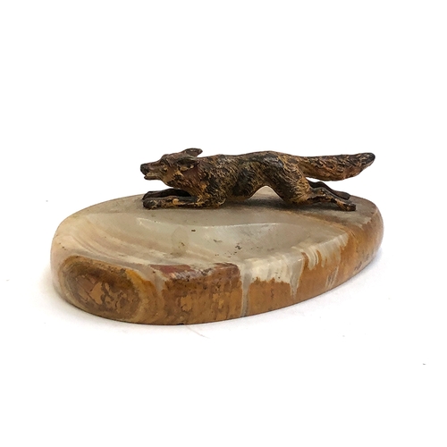 117 - An onyx pin dish with cold painted bronze running fox, the fox 9.5cm long