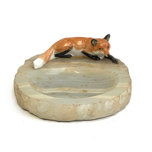 118 - An onyx pin dish with ceramic recumbent fox, the fox approx. 11cm long