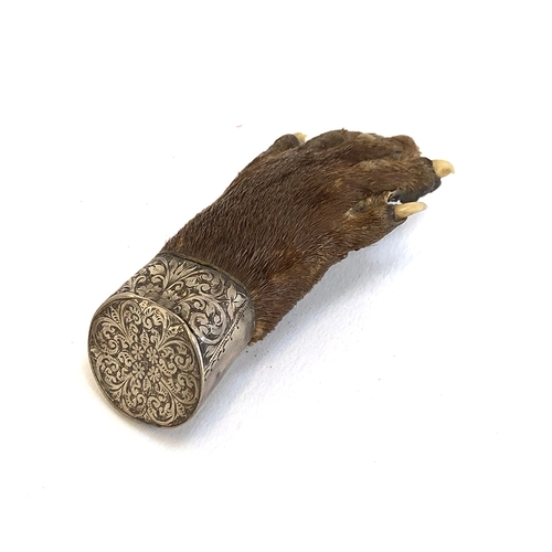 40 - A 19th century otter pad brooch in an engraved silver mount, 8.5cmL
