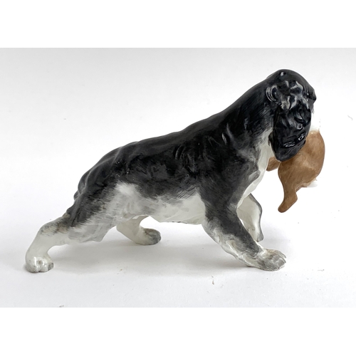 127 - A Royal Worcester porcelain figure of a spaniel holding a rabbit, model number 3310, 9cmH