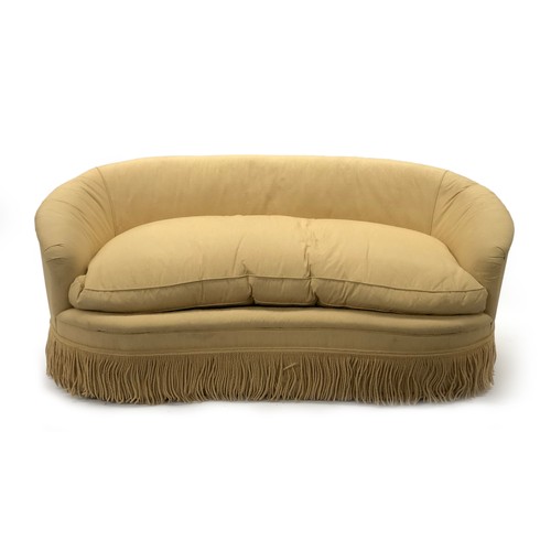 522 - A contemporary Peter Dudgeon serpentine shaped sofa, upholstered in a yellow striped fabric, with on... 