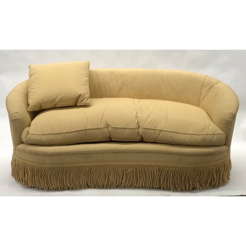 522 - A contemporary Peter Dudgeon serpentine shaped sofa, upholstered in a yellow striped fabric, with on... 