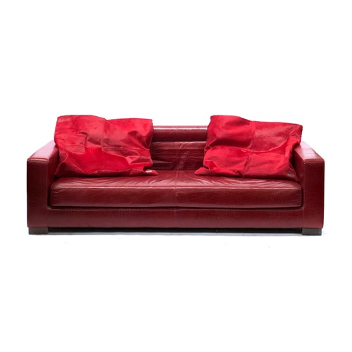 525 - A Fendi Casa three seater sofa, faux crocodile upholstered finish, with two Fendi cowhide cushions, ... 