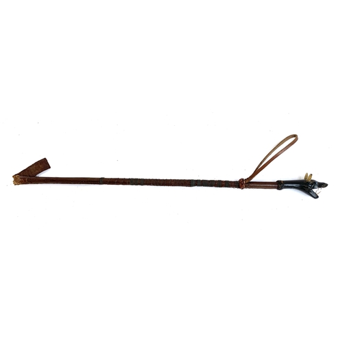 100 - An early 20th century leather horse whip with concealed steel hunting spike, the handle with carved ... 