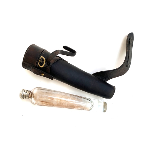 121 - A conical glass hunting flask, in leather holster with saddle furniture, 26cm long