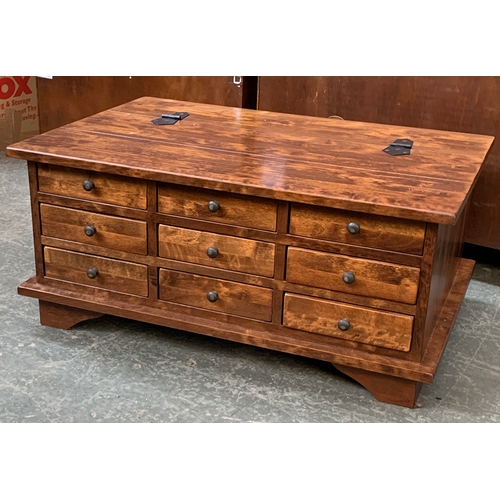 A Laura Ashley coffee table, with nine drawers to one side, the other