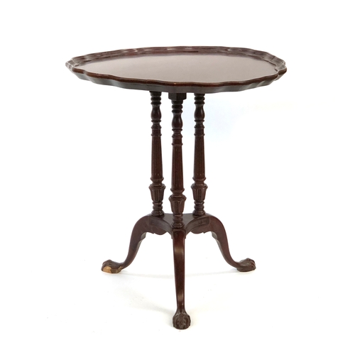 1657 - A reproduction circular occasional table, shaped top, raised on three turned and fluted supports, on... 