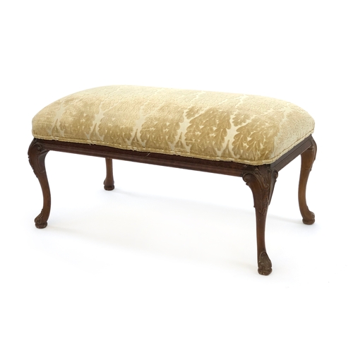 1675 - An upholstered rectangular centre stool, raised on carved cabriole legs, 98cm wide, 50cm deep, 50cm ... 