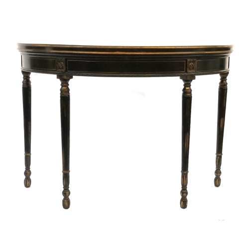 1678 - A pair of ebonised, polychrome and parcel gilt demilune console tables, of recent manufacture, paint... 