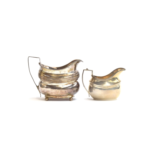 129 - A George III silver milk jug, London 1793, reeded oblong body on bun feet; together with a further G... 