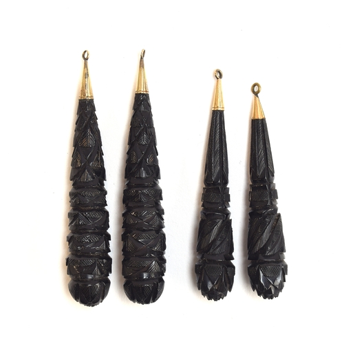 18 - Two pairs of Victorian carved jet torpedo earring drops, with gold caps, 7.6cm long and 6.8cm long