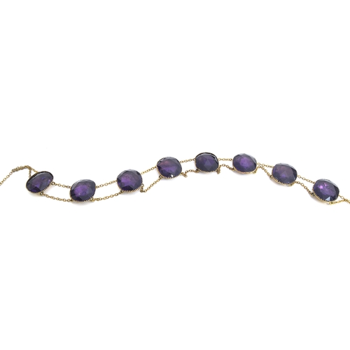 21 - An 18th century 'Queen Anne' amethyst paste riviere necklace, the eight rose cut paste stones each a... 