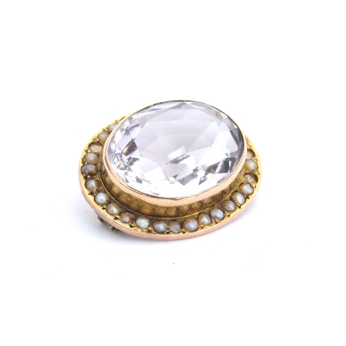 32 - A Victorian yellow metal mounted rock crystal brooch surrounded by seed pearls, 2.5cm wide, gross we... 