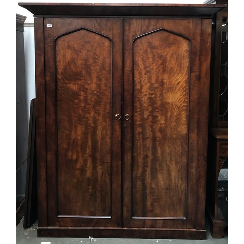 1700 - A large 19th century mahogany wardrobe, with out jutting pediment, two panelled doors opening to sli... 