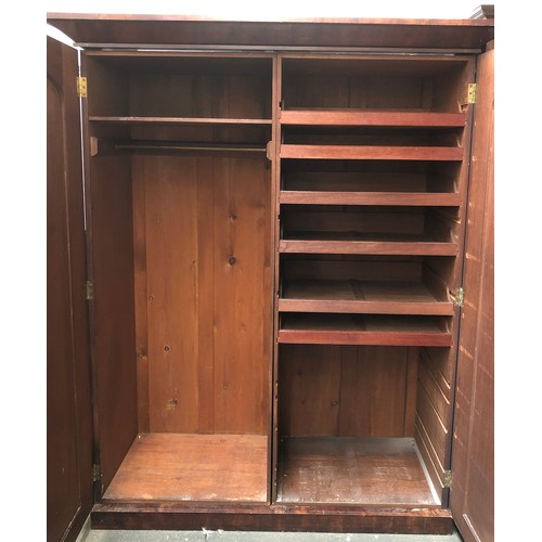 1700 - A large 19th century mahogany wardrobe, with out jutting pediment, two panelled doors opening to sli... 