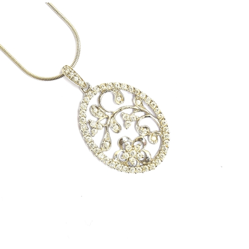 83 - A 14ct white gold and diamond floral pendant of pierced form, 2.2cm long, on a 14ct white gold snake... 